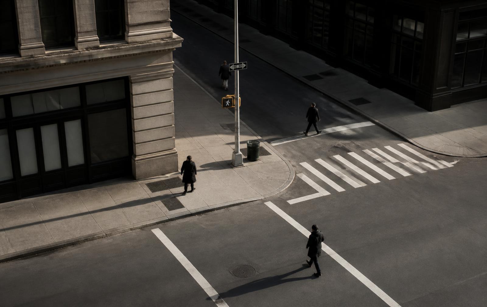An elevated view of a New York street intersection with people crossing