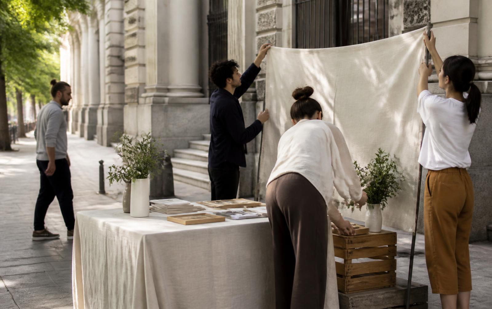 A team setting up an outdoor promotional display on a city sidewalk